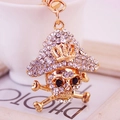 Creative pirate skull keychain with crystal rhinestones on a gold metal pendant - White