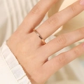 Elegant 2mm rose gold stainless steel ring worn by model on soft fabric background - US 10 / 2mm / Rose Gold