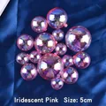 Close-up of 5cm iridescent pink decorative cake topper balls on blue satin fabric - 5cm / Pink Dazzling