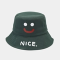 Detail of a dark green bucket hat featuring a smiley face and white NICE text print - M (56-58cm) / Dark Green