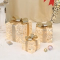Drei champagnergoldene leuchtende Weihnachtsgeschenkkartons mit warmen LED-Lichtern - Champagner Gold Pailletten Stil (BY2305)