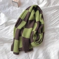 Thick checkered knit scarf in green and brown patterns on a white textured backdrop - Green