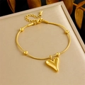 Minimalist gold snake chain bracelet featuring heart pendant and beads for women - Bracelet