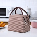 Brown and white striped insulated lunch bag with durable handles on a kitchen counter - Coffee