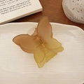 Frosted matte butterfly hair claw clip with a gradient amber finish on a white tray - Coffee Yellow Gradient