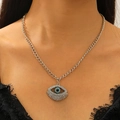 Close-up of Evil Eye pendant with blue rhinestones and metal fringe on model - Necklace / Silver