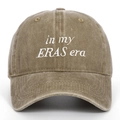 Detail of vintage washed cotton fabric and embroidered 'in my ERAS era' text on baseball cap - Khaki