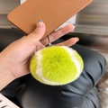 Fluorescent green faux fur tennis ball keychain pendant shown as a fluffy bag charm - Phone Lanyard Style / Green