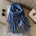 Detail of dark blue silk scarf with delicate gold trim and sewn pearl embellishments - Blue