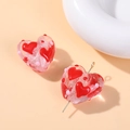 Macro shot of a pink heart-shaped glass bead with red dots for DIY jewelry making - Pink Heart Round Dots Style