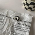 Close-up of a flower-shaped checkerboard hair claw clip made of durable acrylic material - 3# Mini Hair Claw - Flower
