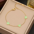 Detail of gold heart charms with green evil eye enamel on a stainless steel chain - Green