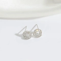 Elegant silver hollow circular stud earrings with clear zircon crystals on white silk - Circular Zirconia (Silver)