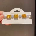 Close-up of a silver bracelet with square yellow and round white zircon crystals - 39# Bracelet - Silver - Yellow