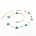 Gold stainless steel necklace featuring green crystal flower beads and adjustable chain - Green Necklace Style