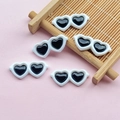 Flat lay of five white heart-shaped resin sunglasses miniatures for DIY craft making - 28*12mm / White