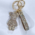 Detail of a luxury sparkling rhinestone bear keychain with a matching glittery hand strap - Mixed Champagne