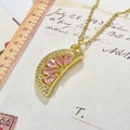Macro shot of gold-plated lemon slice pendant with pink cubic zirconia and micro-pave crystals - Pink-Style 2