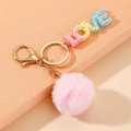 Llavero de letras LOVE de resina arcoíris con pompón rosa y herrajes metálicos dorados - Degradado de Arcoíris con Pompón (LOVE)