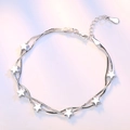 Bracelet double chaîne serpent argenté avec sept breloques étoiles 3D et fermoir réglable - Cuivre plaqué or blanc / Style Étoile