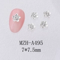 Macro detail of 7mm silver alloy flower nail charms with central crystal on pink manicure - Silver Camellia Rhinestone (A495)