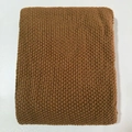 Detailed view of brown waffle knit blanket with thick texture and tassel fringe edges - Coffee