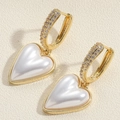 Macro detail of 14K gold plated heart pearl earrings with sparkling paved cubic zirconia - Heart Pearl Earrings / Gold