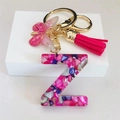 Macro detail of resin letter Z keychain with pink tassels and seashell filling - Rose Red Butterfly Tassel Clip / Letter Z