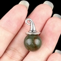 Silver wizard hat pendant with dark green spherical gemstone bead on a dark background - India Agate