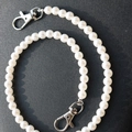 Detail of white faux pearl chain featuring silver metal lobster clasps on each end - White Faux Pearl Style