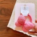Detail of pink cotton-filled fabric bow hair tie on display card with embossed texture - Hair Tie / Rose Red