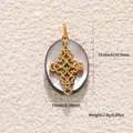 Macro shot of oval mother-of-pearl pendant with gold cross and size specifications - Hand Wrapped Cross Abalone Shell