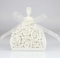 Detail of white laser-cut wedding candy box with elegant translucent ribbon bow - Ivory