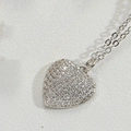 Macro shot of silver heart pendant necklace with shimmering paved crystals on white leather - Large Silver Heart (XL4092-1)