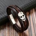 Close-up of brown braided leather skull bracelet with a secure silver magnetic clasp - Coffee + Silver