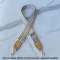 Detail of adjustable woven bag strap with white arrow pattern and gold metal lobster clasps - Apricot with White Arrow - Apricot Leather