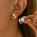 Elegant gold tulip pearl earrings with double-pearl design shown on ear and in hand - ER854-01-Double Pearl