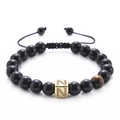 Macro detail of tiger eye stone and gold-plated letter N bead on black onyx bracelet - Letter N-Black Agate Bracelet