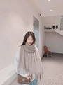 Soft khaki cashmere-blend scarf with fringe tassels worn over a white sweater - Shrimp Color