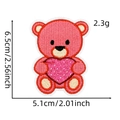 Detailed embroidery of a pink bear holding a heart patch with 6.5x5.1cm dimensions - Style 18 (Pink Bear Heart)
