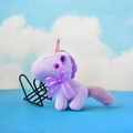 Nahaufnahme eines lila Einhorn-Plüschschlüsselanhängers mit rosa Horn und Lavendelschleife - Lila / 12cm