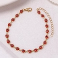 Close-up of golden anklet featuring red evil eye charms and adjustable chain extender - Gold Base Red
