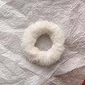Detailed view of plush white faux rabbit fur hair scrunchie on textured background - White