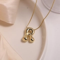 Polished 18K gold plated bubble letter R pendant necklace on white ceramic surface - Letter R (Single Pendant)