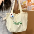 Cream canvas tote bag with green lettering, drawstring design and plush rabbit charm - Rice White with Rabbit Charm