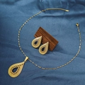 Detail of gold necklace and teardrop earrings set with black gemstones on blue silk - E6107-2/Gold Waterdrop Hollow Black Stone