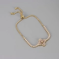 Macro detail of gold bolo bracelet featuring a pink zirconia flower and slider clasp - Gold Pink Zirconia