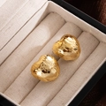 Minimalist gold heart stud earrings with a textured hammered finish in a jewelry box - Gold Heart