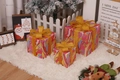 Three colorful Christmas gift boxes in pink yellow and blue with gold glitter bows - Magic Patterns Christmas Gift Box