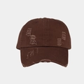 Close-up of distressed ripped details on a dark brown washed cotton baseball cap - Coffee